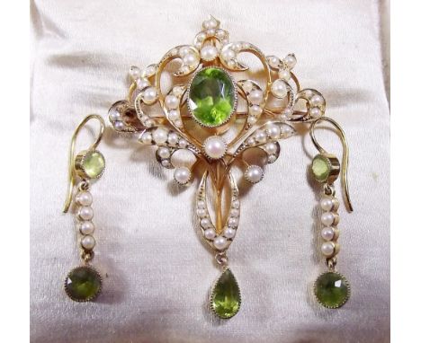 An Edwardian gold openwork pendant/brooch set seed pearls and peridot and pair of matching seed pearl and peridot drop earrin