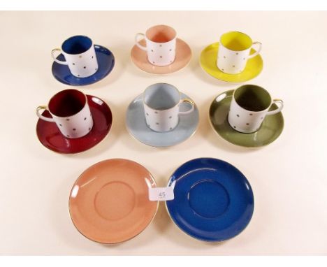 A harlequin Susie Cooper set of six coffee cups and eight saucers decorated gilt stars 