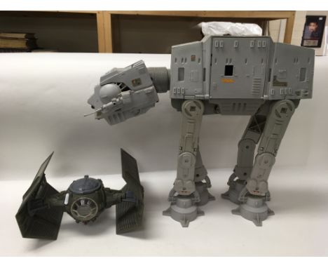 A collection of vintage Star Wars vehicles including an AT-AT Walker, a boxed Return of The Jedi AT-ST Scout Walker, a snowsp