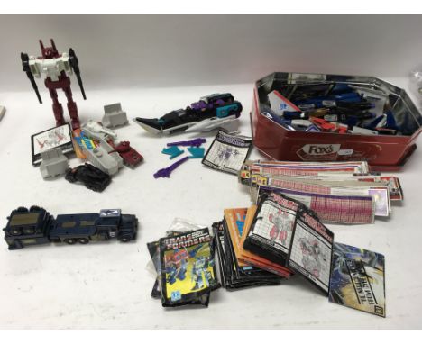 A collection of vintage Transformers figures and accessories.