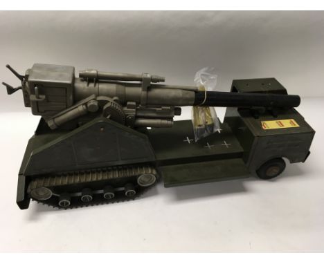 A tin plate vintage battery operated Louis Marx with an atomic cannon truck and original box.