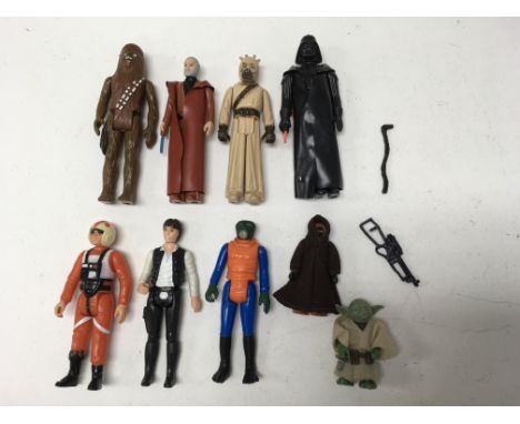 A collection of vintage Star Wars figures including Han Solo, Yoda, Walrus Man, Jawa, Luke (X-Wing pilot dress), Darth Vader 