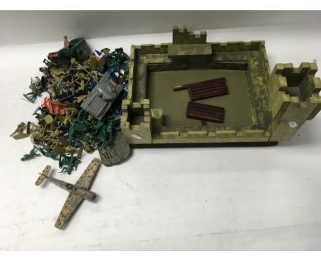 A fort, collection of toy soldiers and Dinky plane.
