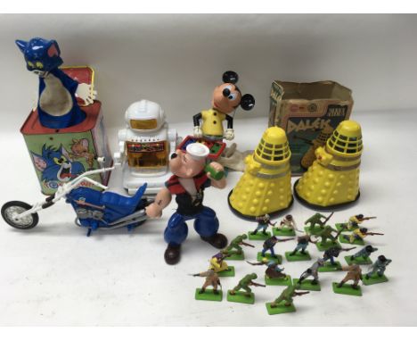 A small collection of unboxed Britains soldiers, a figure of Mickey Mouse playing a xylophone by Kohner brother No. 721, a Po