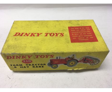 A boxed Dinky Toys farm tractor and hay rake No. 310