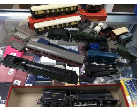 A collection of playworn Hornby OO scale railway engines, carriages, goods wagons, buildings etc