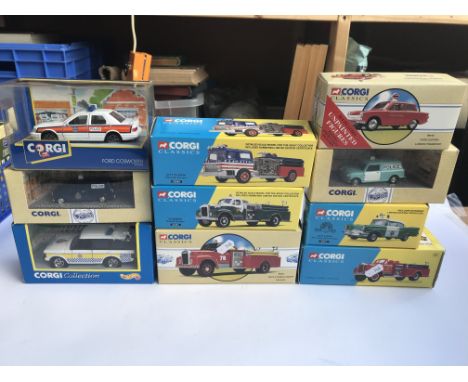 A box containing boxed Corgi/Corgi classic emergency services including fire engines & police cars.
