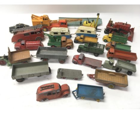 A collection of unboxed Dinky Toys including a mounted crane, bulldozer, lorries etc