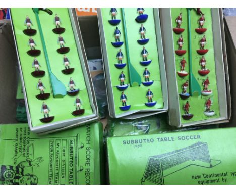 A box of various Subbuteo items including teams, goals, scoreboard, pitch, corner flags,