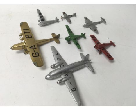 A collection of unboxed Dinky Toys aeroplanes together with a collection of 7 various clockwork toys including a rare teddy b