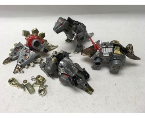 A collection of 4 vintage Transformer Dinobots.