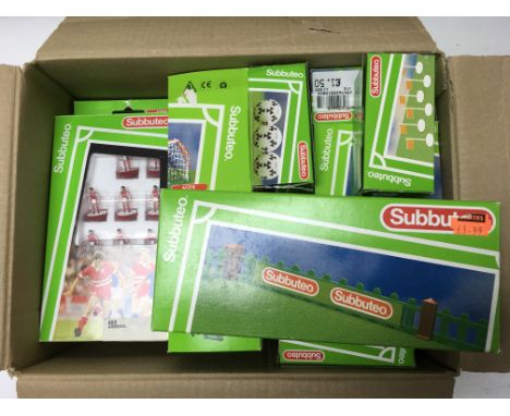 A box of Subbuteo teams and accessories including footballs, cups and goal posts.