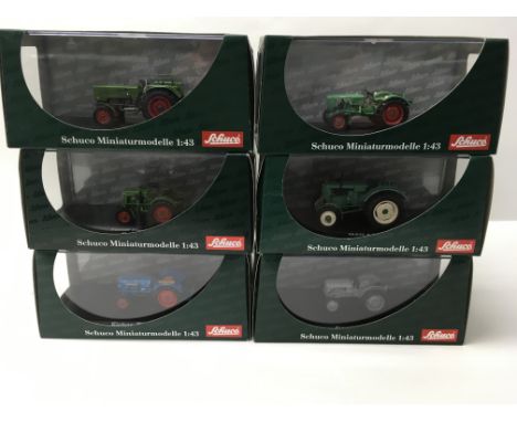 A collection of six 1:43 scale boxed Schuco model tractors.