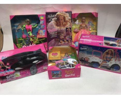 A collection of boxed Barbie dolls including biking Barbie, Birthday party, share a smile Becky, sparkle beach Barbie, ocean 