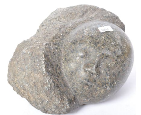 A vintage 20th Century granite stone carving of a child babies face. Measures approx. 22cm x 12cm x 14cm