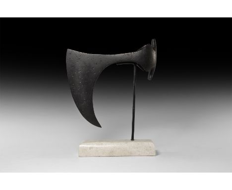 9th-11th century AD. An iron axehead with long, deeply curved blade, short neck, socket with triangular wings above and below