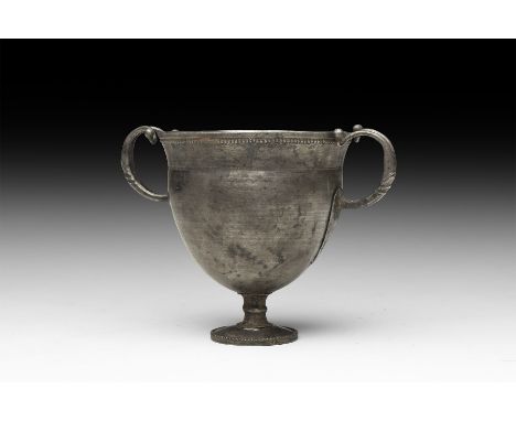 1st century BC. A sheet silver drinking cup comprising a foot with beaded rim, balustered stem, mammiform body with flared mo