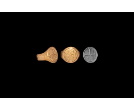 14th-15th century AD. A gold finger ring comprising a broad lentoid-section hoop, discoid bezel with beaded border, heraldic 