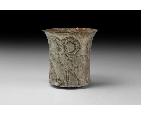 2nd millennium BC. A silver cylindrical cup with slightly flared rim; three ibex in light repoussé, each with lightly incised