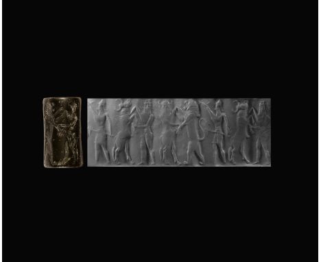 24th-22nd century BC. A black agate cylinder seal with rather flat engraving but well-detailed, on the left a facing nude la?