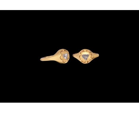 15th-16th century AD. A gold ring comprising a D-section hoop with heart-shaped panel to the underside, round bezel with hexa