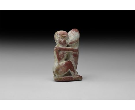Late Period, 664-332 BC. A composition amulet in the form of a seated figure embracing an erect phallus.  33.4 grams, 57.5mm 
