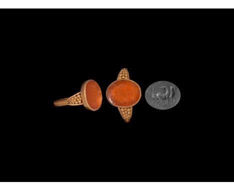 3rd-4th century AD. A gold ring comprising a flat hoop with beaded median band flanked by plain hoops, triangular shoulders w