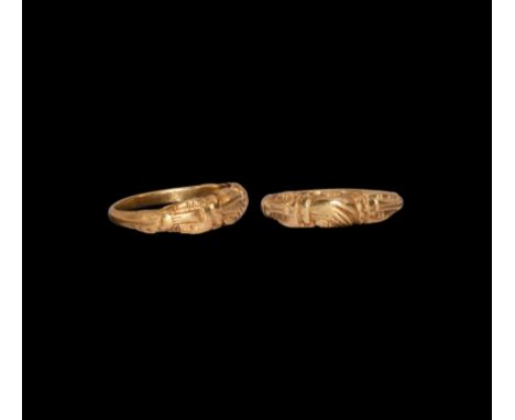 15th-16th century AD. A gold ring with shank widening slightly to the centre; the bezel in the form of a pair of clasped hand