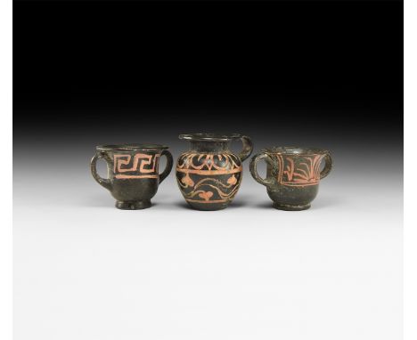 4th century BC. A group of three miniature Xenon-ware vessels comprising: an olpe vase with single lateral handle, painted oc