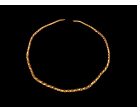 9th-11th century AD. A penannular neck-ring formed from a square-section bar, twisted about its own axis to produce a spiral 