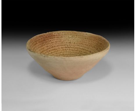 4th-8th century AD. A ceramic flat-based bowl, inscribed in spiral from the bottom inner wall to the rim with Aramaic text.  