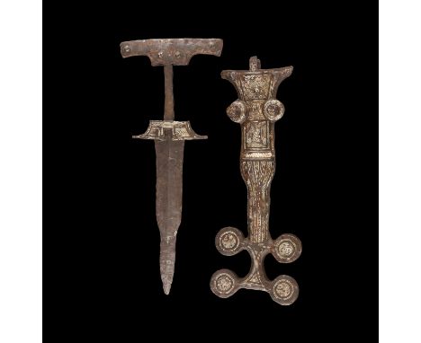 4th-3rd century BC. An iron dagger and associated scabbard; the dagger with carp's tongue blade, flared lower guard, rounded 