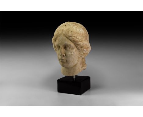 1st century BC-1st century AD. A carved marble bust of a youthful female, possibly a goddess, with hair parted in the centre 