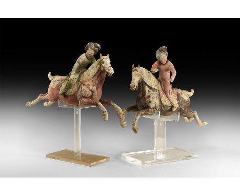Tang Dynasty, 618-906 AD. A pair of ceramic polo player figurines on custom-made stands comprising: one in active pose with h