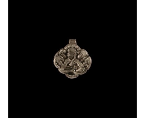 9th-10th century AD. A silver pendant with facing seated figure, probably the goddess Freya, with hands raised to grip her ha