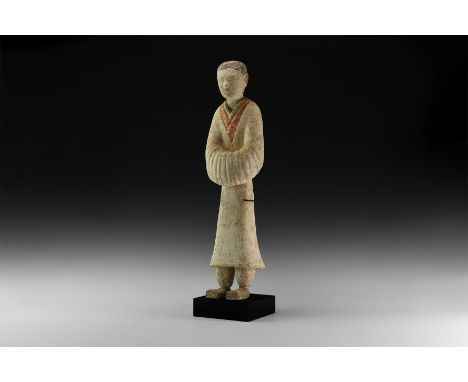 Han Dynasty, 206 BC-220 AD. A ceramic figure of a courtly attendant with short hair, layered robes with V-shaped necklines, h