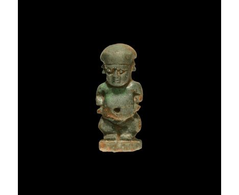 Late Period, 664-332 BC. A glazed faience amulet of Ptah-Soker in the form of a bandy-legged dwarf standing on a rectangular 