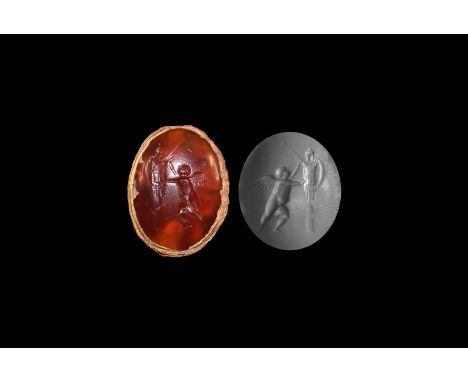 1st-3rd century AD. A gold pendant with triangular granule decoration to the edge; set with carnelian engraved with Cupid rai
