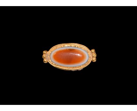 Seleucid Period, 2nd-1st century BC. A gold oval pendant with six beads of gold to the ends forming suspension loops, set wit