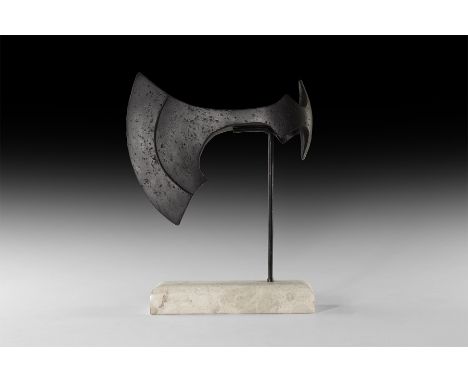9th-11th century AD. An iron axehead with slender curved blade with reinforced cutting edge and chin to the lower edge, round