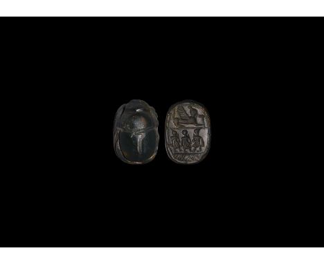 7th-5th century BC. A carved obsidian scarab with intaglio sphinx above a frieze of three profile figures. 3.30 grams, 17.49m
