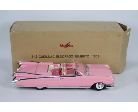 Maisto - A boxed Maisto 1:12 scale Cadillac Biarritz. This large model in pink appears to be in Excellent overall condition p