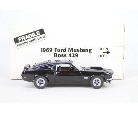 Danbury Mint - A boxed 1:24 scale diecast 1969 Ford Mustang Boss 429 by Danbury Mint. The model appears to be in Mint conditi