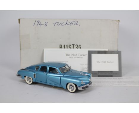 Franklin Mint - A boxed 1948 Tucker in 1:24 scale # B11ST35. The model appears in Mint condition in its original packaging wi