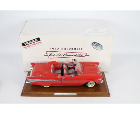 Danbury Mint - A boxed 1:12 scale 1957 Chevrolet Bel Air Convertible by Danbury Mint. The model in red appears to be in Very 