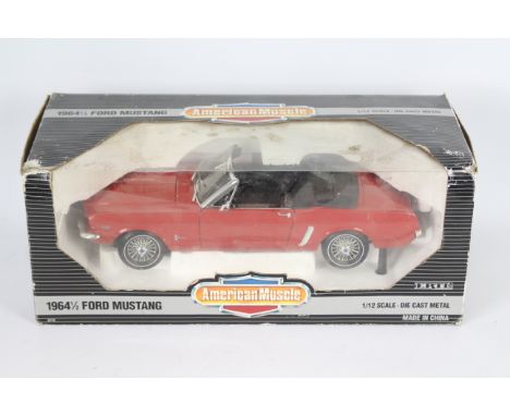 Ertl - A boxed Ertl 'American Muscle' 1:12 scale diecast #8776 1964½ Ford Mustang. The large model in red appears to be in Ve