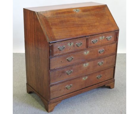 A George III oak bureau, on bracket feet, 103cm