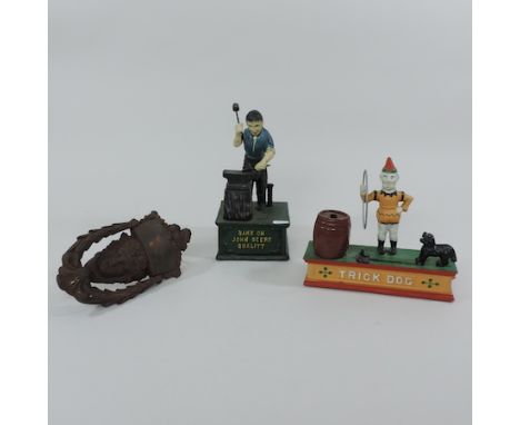 A cast iron advertising money box, 24cm tall, together with another and a cast iron door knocker