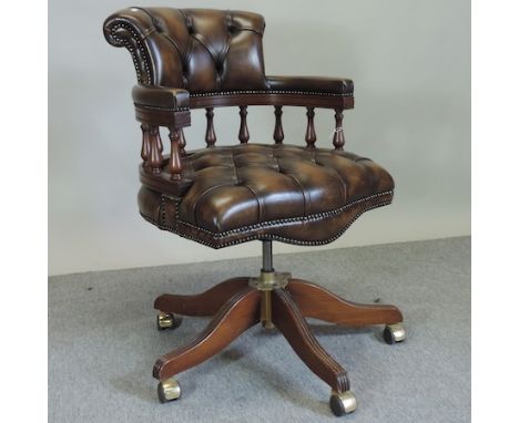 A leather button back swivel desk chair