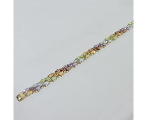 A coloured gemstone bracelet, set with peridot, citrine, garnet, topaz, and amethyst